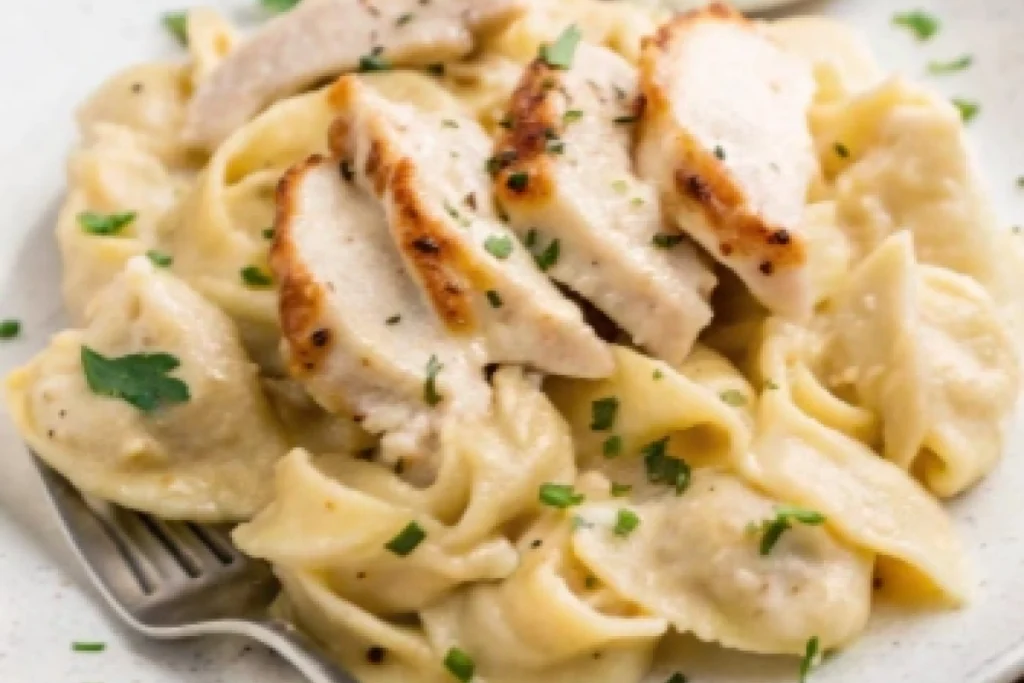 Chicken tortelloni alfredo served in a bowl, a delicious copycat recipe.